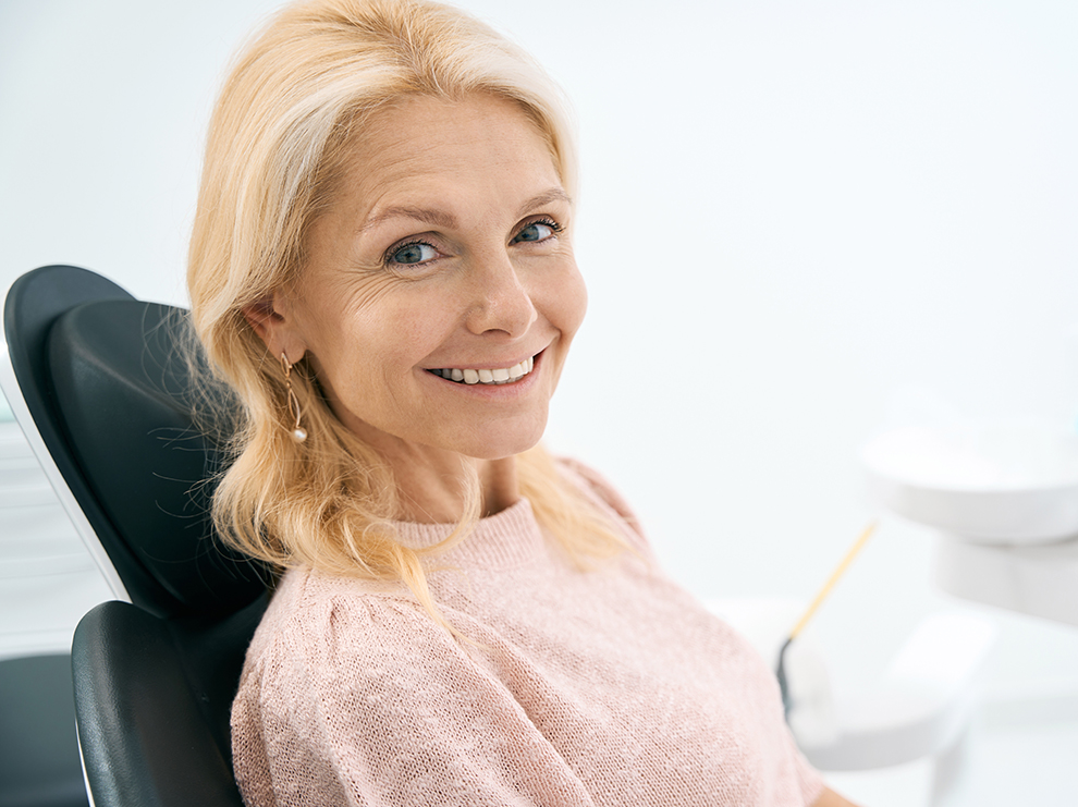 Blonde woman smiling after dental hygienist appointment